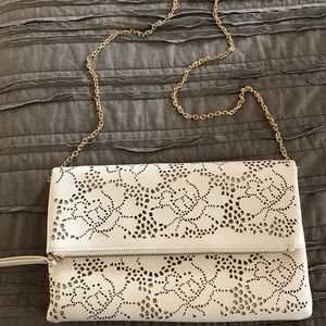 Laser cut cream colored chain clutch